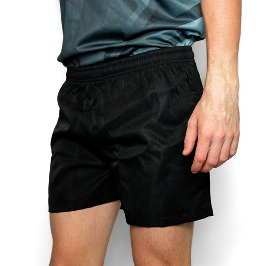 Silver Fern Black Rugby Shorts. Rugby Player Posing. White Background.