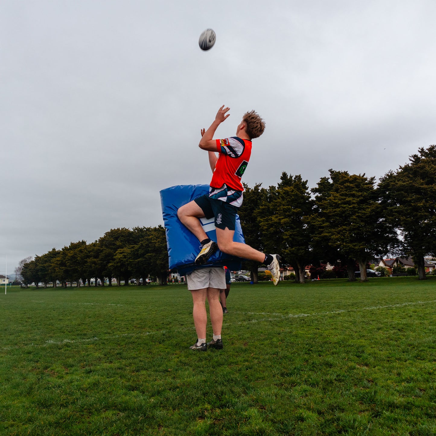 Hit Shield Jump and Catch Action Shot Lifestyle Image