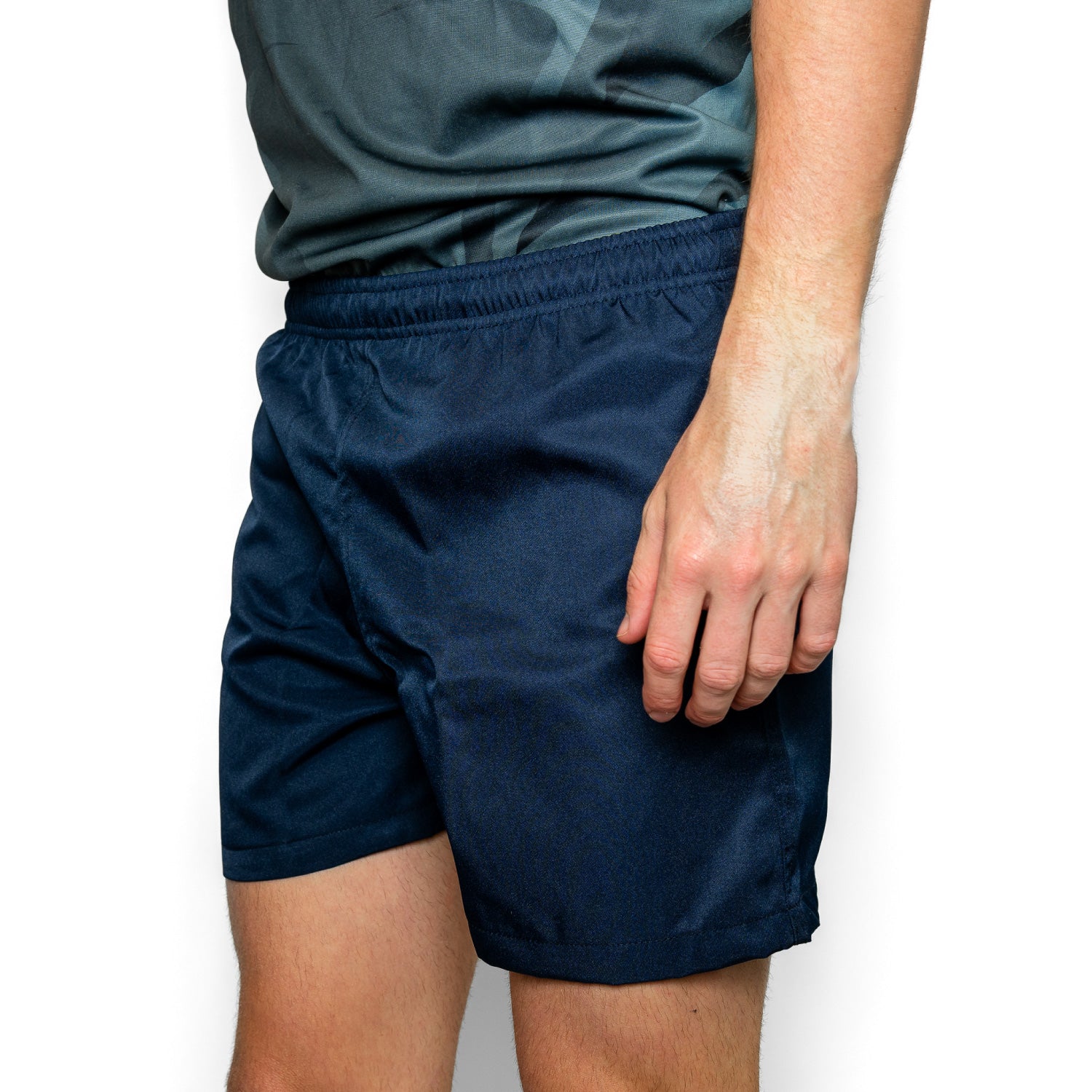 Silver Fern Navy Blue Rugby Shorts. Rugby Player Posing. White Background.