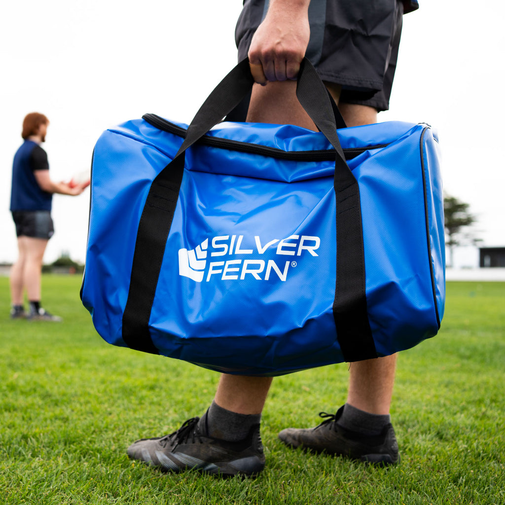 Silver Fern Blue Large PVC Gear Bag, lifestyle shot, athlete holding the bag.