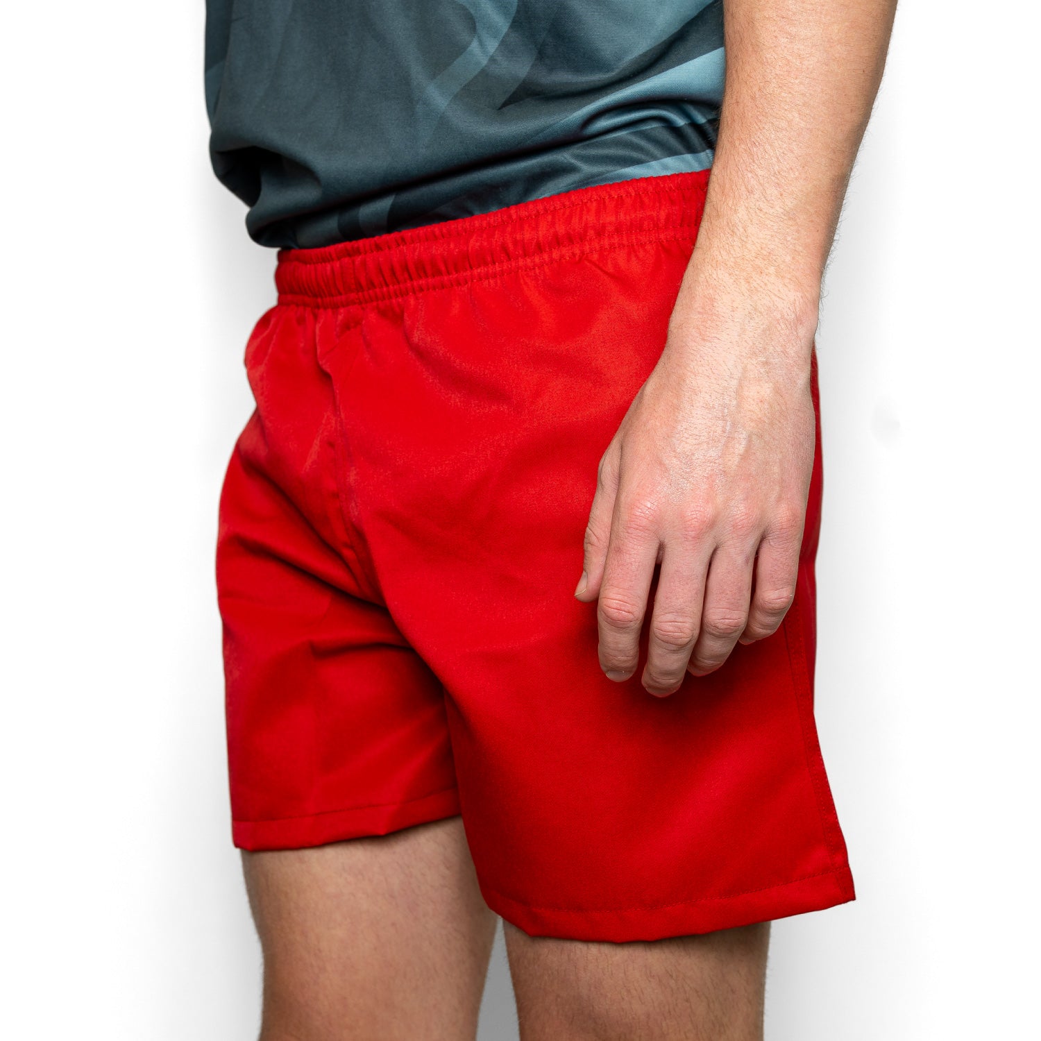 Silver Fern Red Rugby Shorts. Rugby Player Posing. White Background.