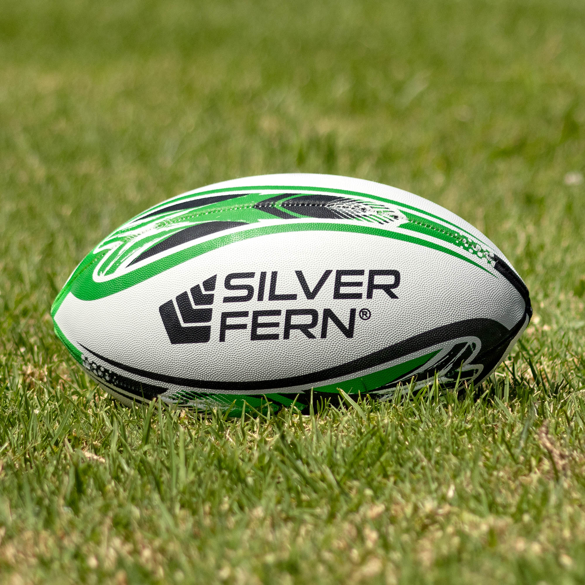 Silver Fern League Mod Trainer Size 4, Lifestyle shot, sitting on a rugby field
