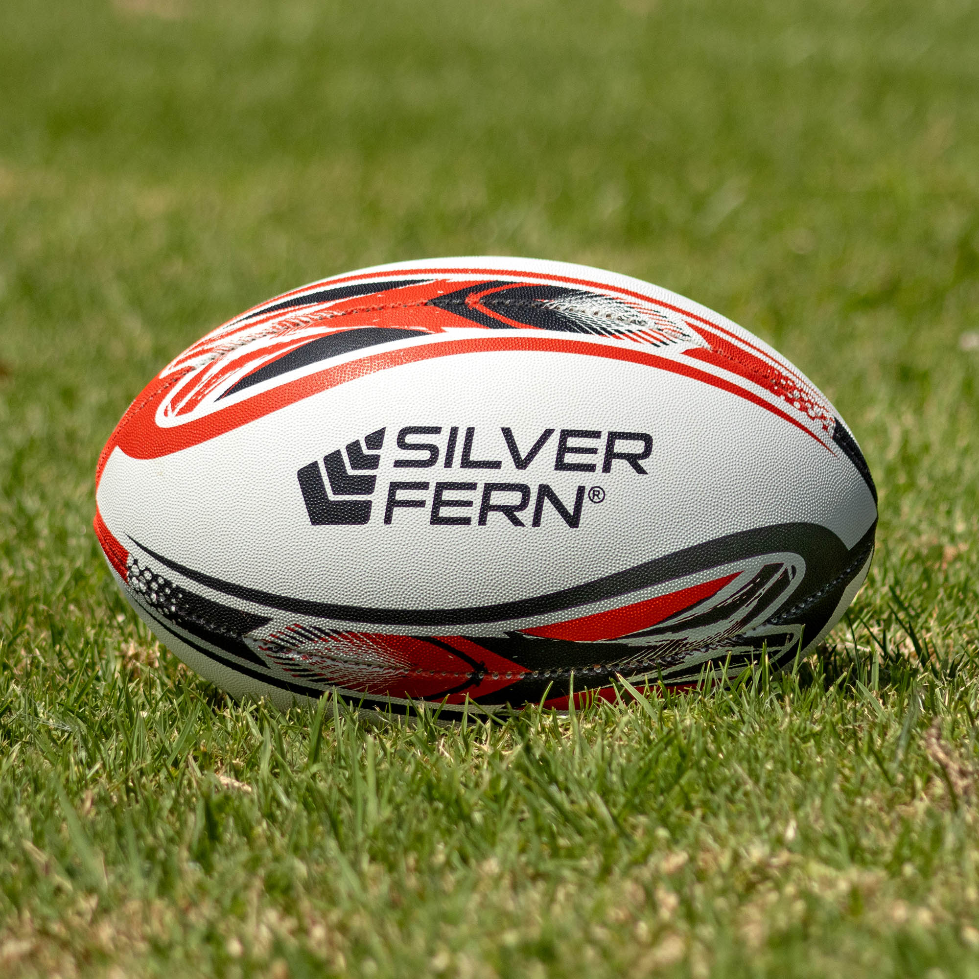 Silver Fern League Ultima Premium Trainer Size 5, Lifestyle shot, sitting on a rugby field

