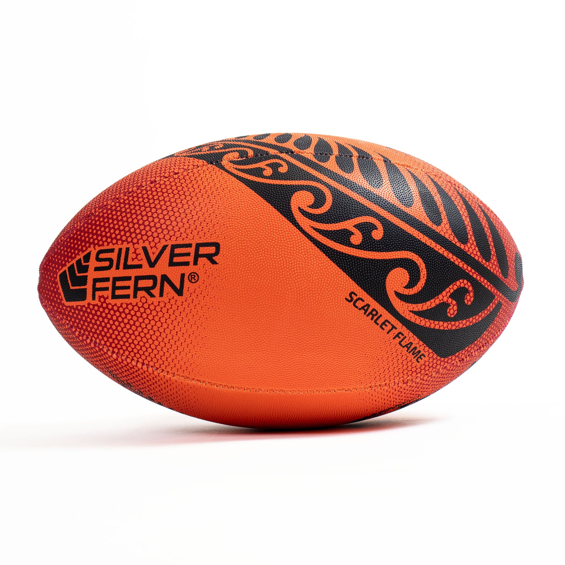 Orange rugby ball with black patterns and 'Silver Fern' branding on a white background