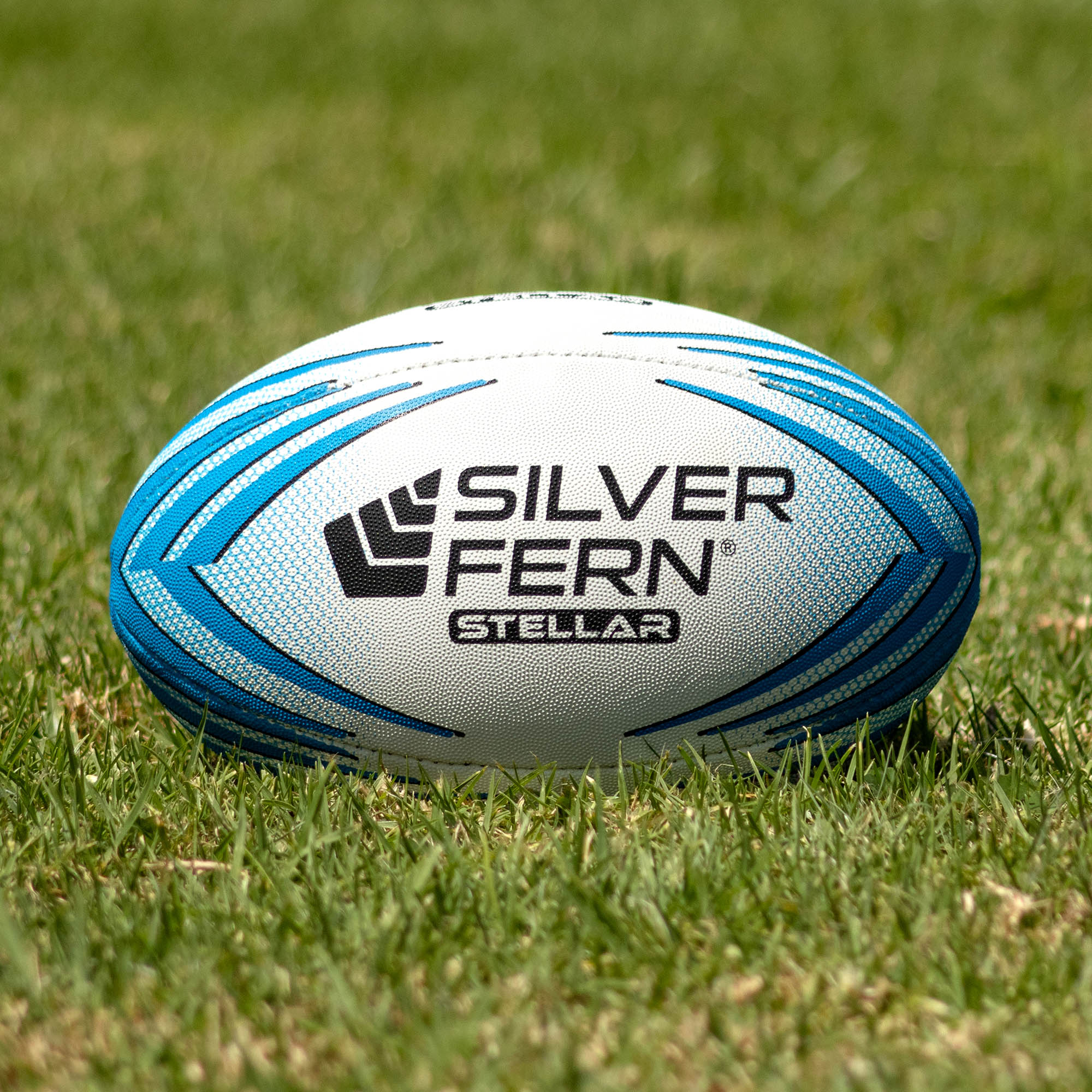 Silver Fern Stellar Premium Trainer Size 3, Lifestyle shot, sitting on a rugby field