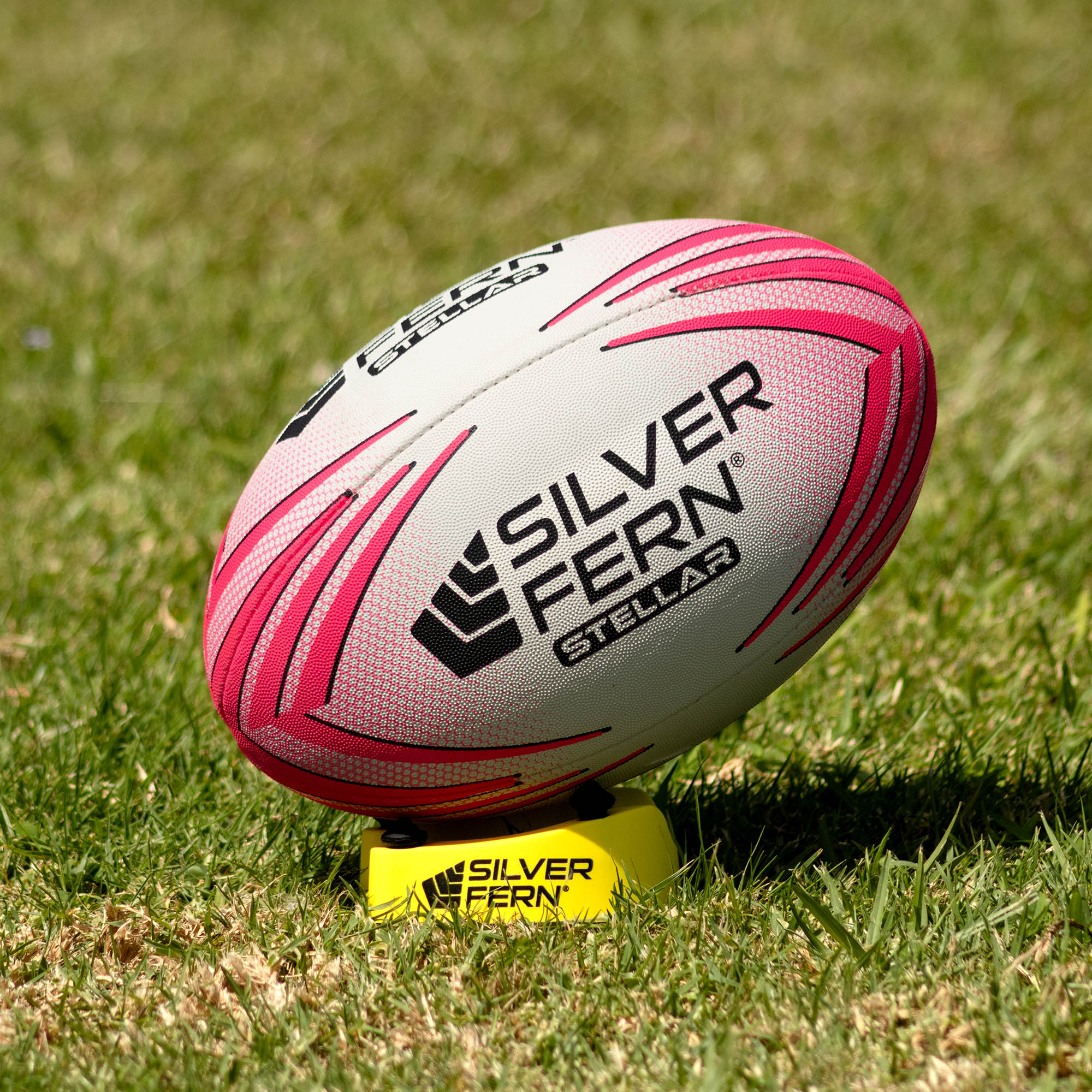 Silver Fern Pink Stellar Premium Trainer Size 5, Lifestyle shot, sitting on a kicking tee