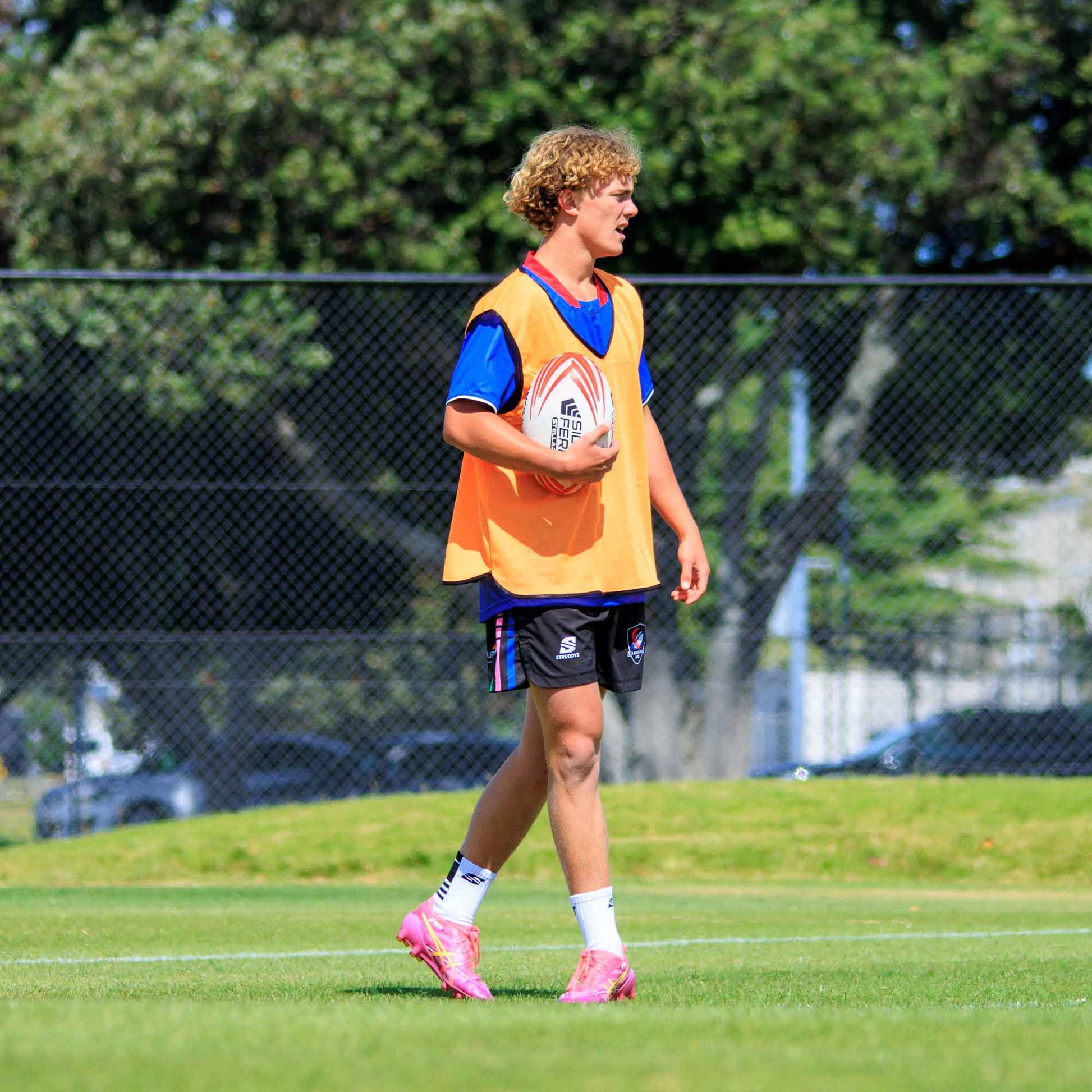 Silver Fern Rugby Premium Trainer Stellar Ball, Red, Size 5, ball in players hand, lifestyle.