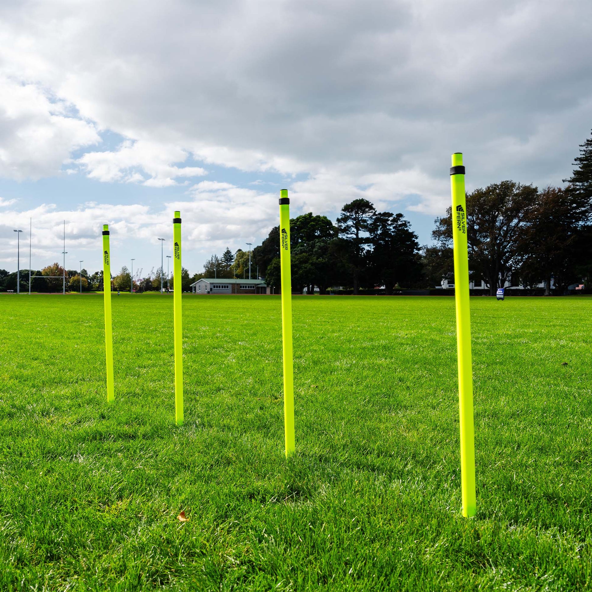 A set of Telescopic Agility Poles stacked in a grass Rugby field.